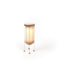 Small lamp with wooden base and white shade on a white background