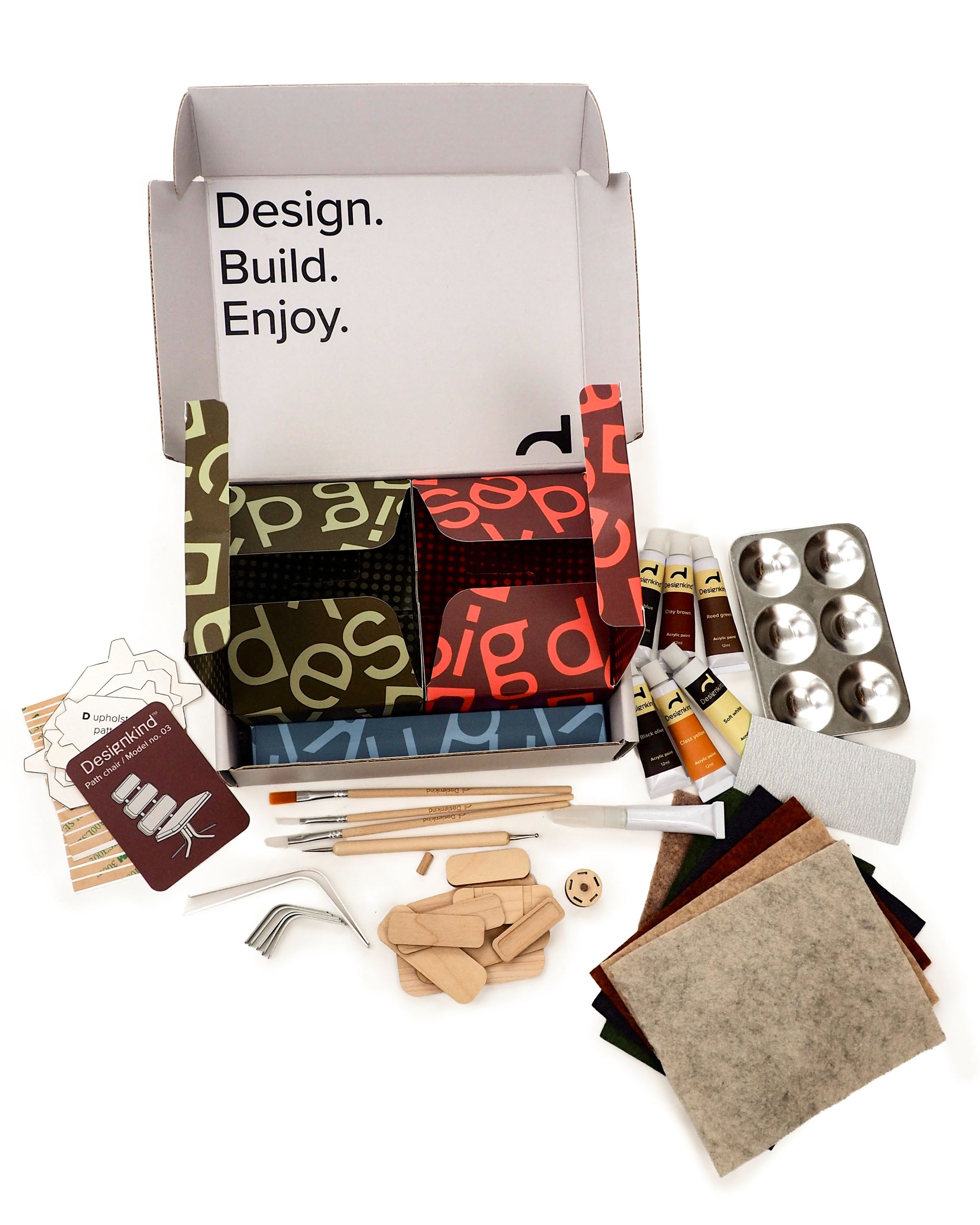 Craft kit with various materials and tools on a white background