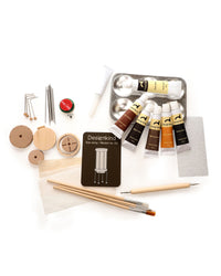 Set of art supplies including paint tubes, brushes, and tools on a white background