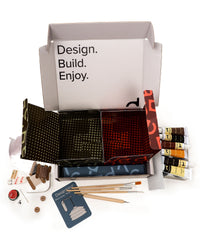 Crafting kit with materials and tools on a white background